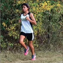  ?? Photos by TIM GODBEE / For the Calhoun Times ?? ( Calhoun’s Adamariz Perez keeps a steady pace during the girls race on Tuesday. ( Sonoravill­e’s John Graves (left) leads Calhoun’s Jesus Gonzalez during the boys race.