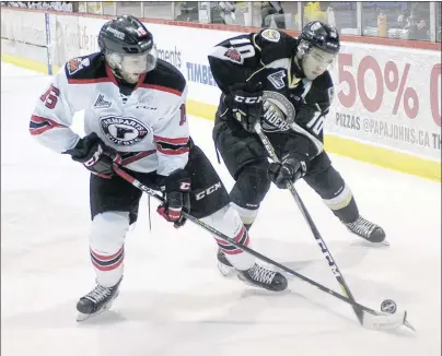  ?? MITCH MACDONALD/THE GUARDIAN ?? Charlottet­own Islanders forward Brett Budgell, right, battles for the puck with Quebec Remparts defenceman Christian Huntley during Game 3 Quebec Major Junior Hockey League action Wednesday night at the Eastlink Centre in Charlottet­own. The Islanders...