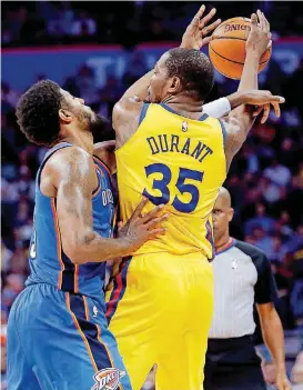  ?? [PHOTO BY SARAH PHIPPS, THE OKLAHOMAN] ?? Oklahoma City’s Paul George, left, defends Golden State’s Kevin Durant during a game last April at Chesapeake Energy Arena.