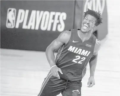 ?? ASHLEY LANDIS/AP ?? Heat forward Jimmy Butler reacts after scoring against the Pacers during the second half of Tuesday’s playoff opener.