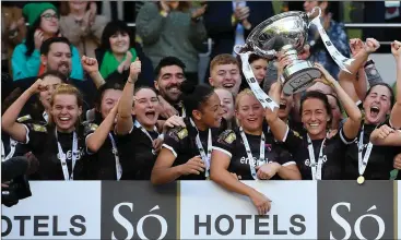  ??  ?? The moment of glory as captain fantastic Kylie Murphy - scorer of the cup-winning goal - lifts the trophy.