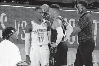  ?? PHOTO/MARK J. TERRILL] [AP ?? Oklahoma City's Dennis Schröder (17) and Houston's Russell Westbrook, center right, talk after the Rockets won Game 7 Wednesday night to advance to the Western Conference semifinals against the Lakers.