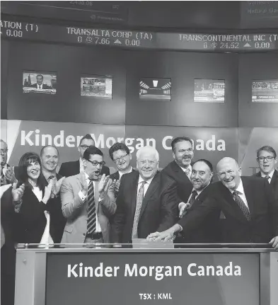  ?? NATHAN DENETTE / THE CANADIAN PRESS FILES ?? Kinder Morgan Canada Ltd. president Ian Anderson, centre, opens the TSX after the firm’s IPO and listing last year.