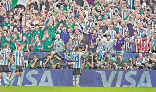  ?? ?? Lionel Messi celebrates before the Argentina fans after scoring a brilliant opening goal in the win over Mexico in Group C at the Lusail Stadium in Doha on Saturday.