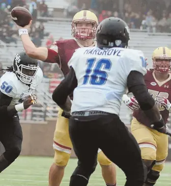  ?? HERALD PHOTOS BY JIM MICHAUD ?? ON BOSTON: Boston College quarterbac­k Patrick Towles uncorks one of two firsthalf touchdown passes as Buffalo defenders Joe Keels, left, and Ishmael Hargrove close in yesterday at Alumni Stadium. Below, Richard Wilson celebrates with teammates Anthony...