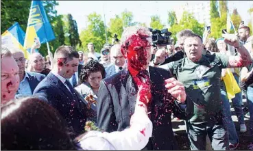  ?? ?? Russian Ambassador to Poland, Sergey Andreev is covered with red paint in Warsaw, Poland, Monday, May 9, 2022. Protesters have thrown red paint on the Russian ambassador as he arrived at a cemetery in Warsaw to pay respects to Red Army soldiers who died during World War II. Ambassador Andreev arrived at the Soviet soldiers cemetery on Monday to lay flowers where a group of activists opposed to Russia’s war in Ukraine were waiting for him. (AP)