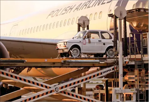  ?? REUTERS. ?? A Fiat 126p, which Polish fans have bought for US actor Tom Hanks as a souvenir, is seen during loading on board of the LOT Polish Airlines Dreamliner to fly to Los Angeles in Warsaw, Poland on Monday. REUTERS