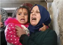  ?? Reuters ?? A woman carries the daughter of palestinia­n Khaled Qwaider, who was killed in the Isrealis strike, during his funeral in Khan Younis, in the southern gaza strip on Monday. —