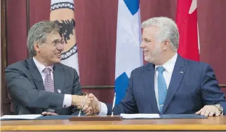  ?? JACQUES BOISSINOT/THE CANADIAN PRESS ?? Matthew Coon Come, grand chief of the Grand Council of the Crees, with Premier Philippe Couillard after they signed an agreement, Monday, at the legislatur­e in Quebec City.