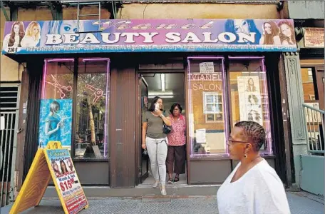  ?? Photograph­s by Carolyn Cole
Los Angeles Times ?? VIANEL BEAUTY SALON in East Harlem sits across the street from Our Lady Queen of Angels School, where Pope Francis will meet with pupils, refugees and immigrants Sept. 25. The salon’s workers hope he will come their way, maybe to bestow a blessing or...