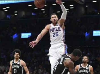  ?? KATHLEEN MALONE-VAN DYKE — THE ASSOCIATED PRESS ?? This dunk by 76ers guard Ben Simmons over Nets forward Rondae Hollis-Jefferson was an all-too-rare occurrence Sunday, as the Sixers committed 28 turnovers in a 122-97 loss to Brooklyn.