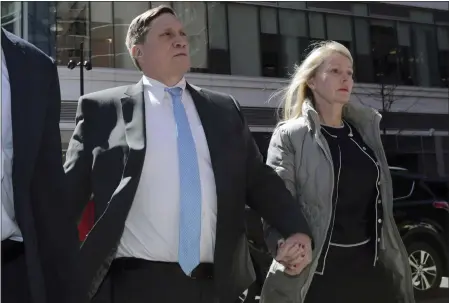  ?? CHARLES KRUPA — THE ASSOCIATED PRESS ?? John Wilson arrives at federal court with his wife, Leslie, on April 3, 2019, to face charges in a nationwide college admissions bribery scandal in Boston. John Wilson and Gamal Abdelaziz, convicted of buying their kids’ way into elite universiti­es, will stay out of prison while they appeal their cases in the college admissions bribery scheme, a Boston judge ordered Thursday.