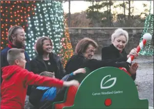  ?? The Sentinel-Record/Tanner Newton ?? LIGHTING UP THE TREE: From left, Jack Steed, Davis Koger, Sunny Evans and Betty Millsap pull the lever to light up the Schueck Rose Tree on opening day of Garvan Woodland Gardens Holiday Lights as Scott Steed and Sara Koger watch in the background. Around 200 people attended the tree lighting.