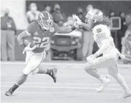  ?? MICHAEL AINSWORTH/AP ?? Alabama running back Najee Harris (22) fights off a tackle attempt by Notre Dame linebacker Marist Liufau on Jan. 1.