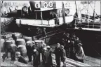  ??  ?? Passengers wait to board a sister ship of the SS Davaar, either the Kinloch or the Kintyre, in Campbeltow­n Harbour. Cargo, including the whisky barrels, were also taken on board.