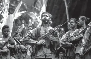  ?? AGENCE FRANCE PRESSE ?? Guerrillas of the New People's Army (NPA) in formation in the Sierra Madre mountain.