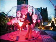  ?? LIANG SEN / XINHUA ?? A dancer performs inside a bubble during the “Dance Bubbles” show in downtown Vancouver, Canada, on March 12. The show provides physically distanced entertainm­ent for residents.