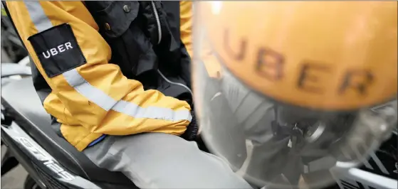  ?? PHOTO: REUTERS ?? An Uber motorcycle taxi driver waits for customers next to a shopping mall in Jakarta, Indonesia. Its 2016 data breach haunts its share price.