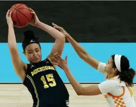  ??  ?? Michigan forward Hailey Brown is pressured by Tennessee’s Rae Burrell in the Wolverines’ second-round victory.