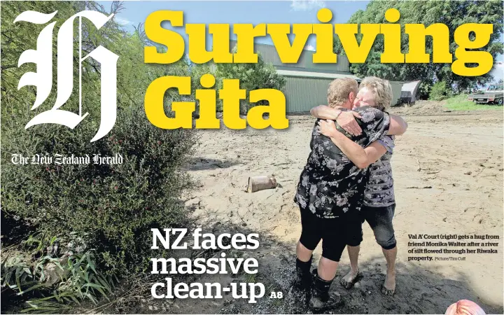  ?? Picture/Tim Cuff ?? Val A’ Court (right) gets a hug from friend Monika Walter after a river of silt flowed through her Riwaka property.