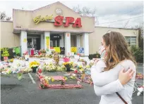  ?? JOHN SPINK/ATLANTA JOURNAL-CONSTITUTI­ON VIA AP ?? Hollis Wright collects her thoughts as she becomes emotional in front of the Gold Spa, where multiple people were killed in a 2021 shooting in Atlanta.