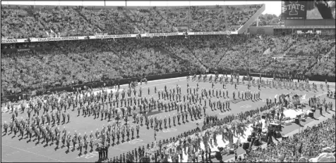  ?? Charlie Neibergall The Associated Press ?? The Iowa State marching band spells out “CBA” during a video board tribute to slain student-athlete Celia Barquin Arozamena before the Cyclones’ 26-13 win over Akron on Saturday.