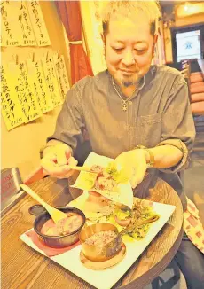  ?? — Photo by The Japan News ?? Owner-chef Yoshiyuki Uwajima prepares tacos using deer meat at ‘French Izakaya UWASHIMA’ in Sumida Ward, Tokyo.