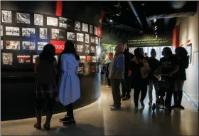  ?? AP PHOTO/JACQUELYN MARTIN ?? People visit the Pulitzer Prize Photograph­y exhibition Dec. 20 at the Newseum in Washington.