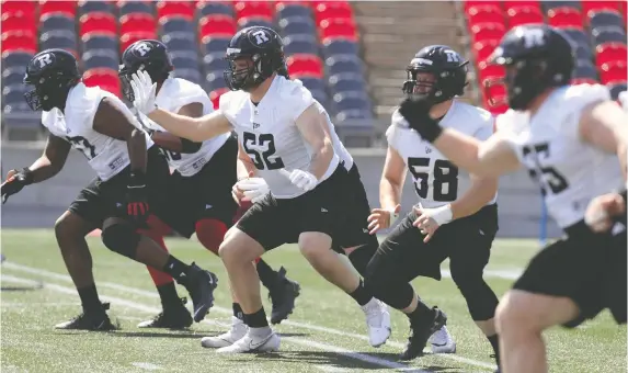  ?? PHOTOS: TONY CALDWELL ?? Offensive lineman Zack Pelehos (52), the Redblacks top pick in last week’s CFL draft, works out during rookie camp on Wednesday.