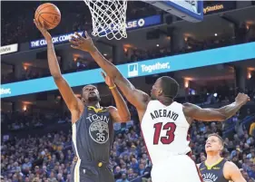  ??  ?? Warriors forward Kevin Durant shoots against Heat center Bam Adebayo on Feb. 10 in Oakland, Calif. KELLEY L COX/USA TODAY SPORTS
