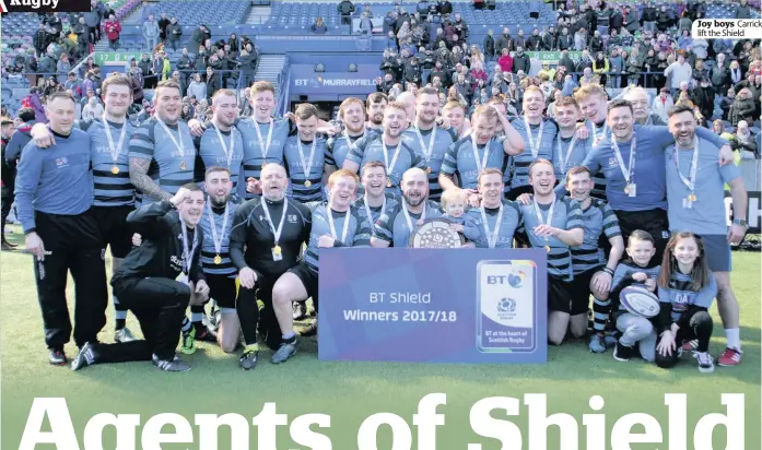  ??  ?? Joy boys Carrick lift the Shield