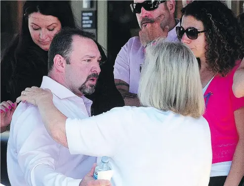  ?? NICK PROCAYLO ?? Mourners, including the father of Aaliyah Rosa, Steve, left, shared their grief at a celebratio­n of life for the seven-year-old girl at Christian Life Assembly in Langley on Aug. 8.