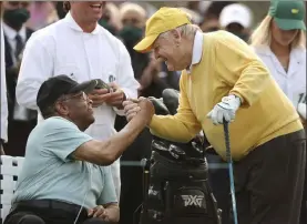  ?? Curtis Compton The Associated Press ?? Honorary starter Lee Elder, left, shakes hands Thursday with six-time Masters champion Jack Nicklaus during the ceremonial tee shots to begin the Masters.