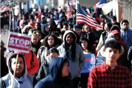  ?? Julio Cortez / AP ?? Diamond Bryant, center, a freshman at James Ferris High School, joins classmates during a student walkout in Jersey City, N.J., in March.