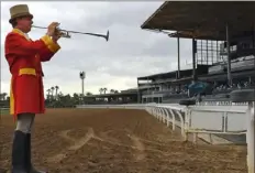  ?? Associated Press ?? Bugler Jay Cohen calls the riders to post before empty stands Saturday at Santa Anita Park in Arcadia, Calif.