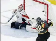  ?? ROSS D. FRANKLIN — THE ASSOCIATED PRESS ?? Washington Capitals goaltender Braden Holtby, left, is scored on by Vegas Golden Knights left wing Tomas Nosek, of the Czech Republic, during the third period in Game 1of the NHL hockey Stanley Cup Finals Monday in Las Vegas.