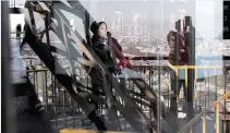  ??  ?? PARIS: A woman looks on at the first floor of the Eiffel Tower in Paris yesterday. —AP