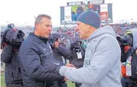  ?? AP FILE ?? Ohio State head coach Urban Meyer, left, and Michigan State boss Mark Dantonio shake hands after the Spartans beat the Buckeyes in 2016. Saturday, Michigan State will look for an upset win over eighth-ranked Ohio State.