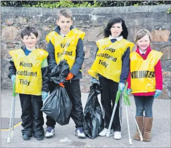  ?? ?? In 2012: Owen Reid, Millar Irwin, Hannah Black and Kelsey Graham were among pupils from Castlehill Primary School who went out on a clean-up. Accompanie­d by teachers and parents, they collected litter from the Meadows Playing Fields and Ralston Road areas around the school.