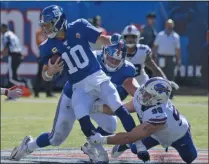  ?? BILL KOSTROUN - THE ASSOCIATED PRESS ?? New York Giants quarterbac­k Eli Manning (10) fumbles the ball as he is tackled behind the line of scrimmage during the second half of an NFL football game against the Buffalo Bills, Sunday, Sept. 15, 2019, in East Rutherford, N.J.
