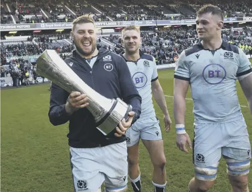  ??  ?? 0 Nick Haining gets his hands on the Auld Alliance trophy after Scotland’s win over France in March.
