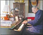  ??  ?? Peter Fuchs plays the piano at his home.