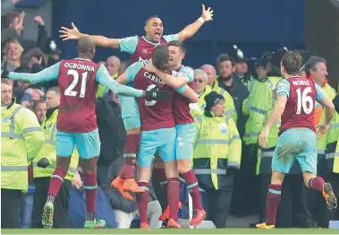  ?? BACKPAGEPI­X ?? TOAST OF THE TOWN: Dimitri Payet is lifted up by his teammates after scoring his side’s third and decisive goal to seal their comeback win against Everton on Saturday.