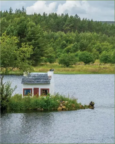  ?? ?? Lairg, which sits on the southeast edge of Loch Shin, attracts visitors who want to photograph the ‘wee hoose’, a tiny whitewashe­d building on an island in the water