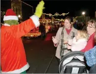  ?? Janelle Jessen/Herald-Leader ?? The Grinch waves to members of the crowd.