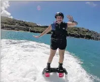  ?? SUBMITTED PHOTO ?? Lesley Carter has proven she’s not afraid of new things, whether it be skydiving, bungee jumping or swimming with sharks. In this photo, the Sydney Mines native is shown flying on water during her trip to the United States Virgin Islands.