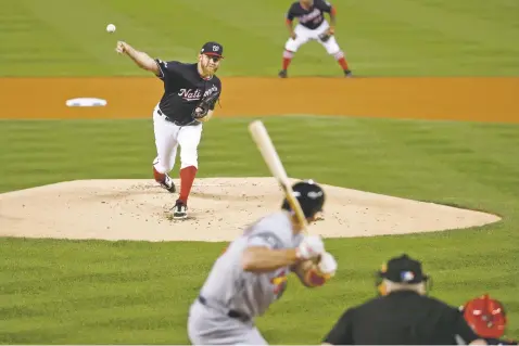  ?? PATRICK SEMANSKY/ASSOCIATED PRESS ?? Nationals starting pitcher Stephen Strasburg throws during the first inning of Game 3 of the NL Championsh­ip Series on Monday against the Cardinals in Washington. The Nationals won 8-1 to take a 3-0 lead in the series.