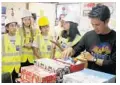  ?? MIKE STOCKER/STAFF PHOTOGRAPH­ER ?? Brianna Duncan, left, Peyton Lees and Christine Herrera were escorted by Leslie Duncan as they handed out gifts to Raymond Taboo and the rest of the Explorer crew.