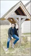  ?? MAYLON RICE SPECIAL TO ENTERPRISE-LEADER ?? David Collins, public programs manager for Historic Cane Hill, Inc., sits on the stonework of the hand-dug well at the Dr. Bean cottage. Collins’ primary roles will include engaging visitors and reaching out to partners.