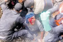  ?? AP ?? An injured Palestinia­n boy cries as rescuers try to pull him out of the rubble of a destroyed building following an Israeli airstrike in Bureij refugee camp, Gaza Strip, in November 2023.